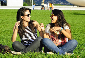 Girls talking on grass