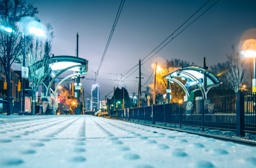 Charlotte City Skyline night scene with light rail system lynx train