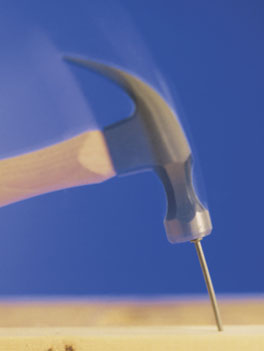 A hammer hitting a nail