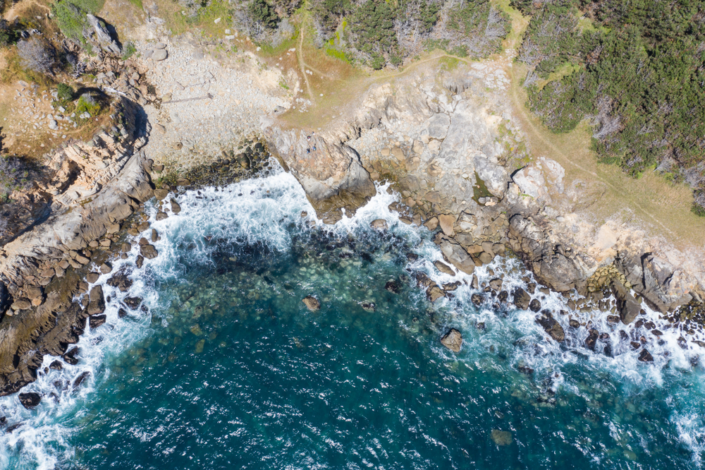 Bird's eye view of the Pacific Ocean washing against the rocky coast of Northern California.