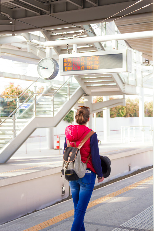 woman waiting for train a station