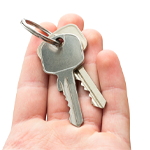 Man's hand holding house keys on white background