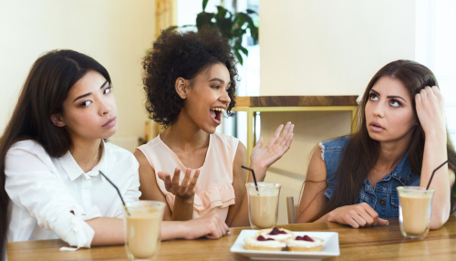 Annoying talkative friend sitting in cafe with girls and storytelling.