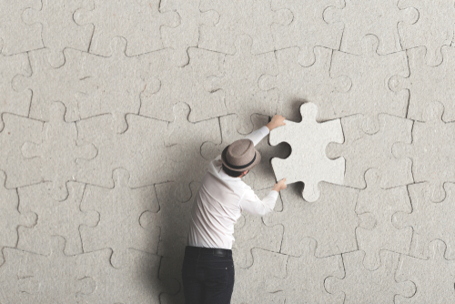 man places last piece of puzzle surreal concept