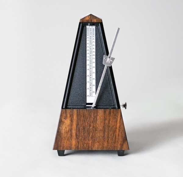Metronome in action, closeup, isolated and on a plain background