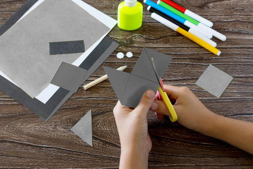 Student cutting paper