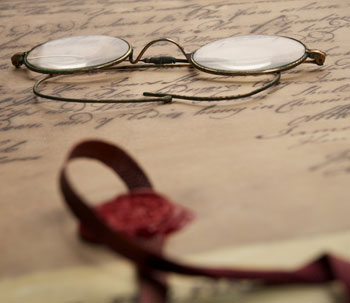 old style glasses sitting on a document