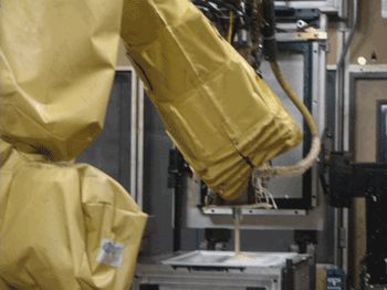 A robotic arm sprays insulating foam at the GE Appliances & Lighting refrigerator manufacturing facility in Decatur, Ala.