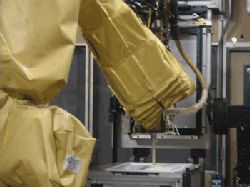 A robotic arm sprays insulating foam at the GE Appliances & Lighting refrigerator manufacturing facility in Decatur, Ala.