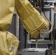 A robotic arm sprays insulating foam at the GE Appliances & Lighting refrigerator manufacturing facility in Decatur, Ala.