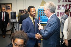 Louisville Mayor Greg Fischer greets student leader Ghadi Nshimiyimani at the launch of the Doss High School mock assembly line