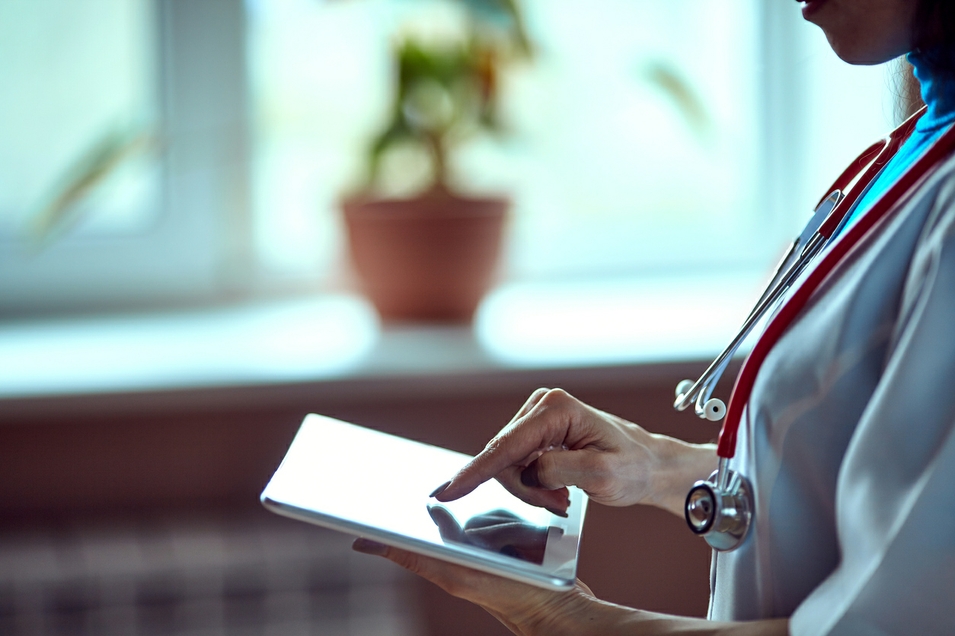 Doctor working on a digital tablet with copy space Doctor working on a digital tablet with copy space