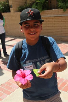 Student with flower and leaf
