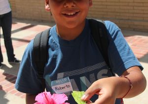 Student with flower and leaf