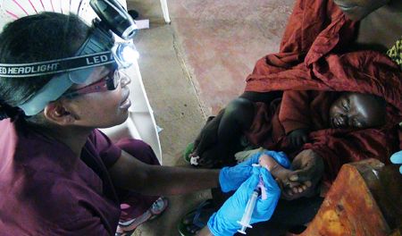 UCLA nurse Millicent Manyore treating Kenyan baby