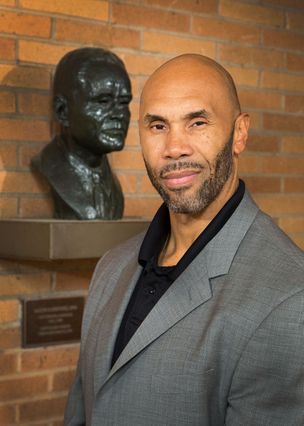Darnell Hunt with bust of Ralph J. Bunche