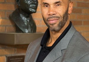 Darnell Hunt with bust of Ralph J. Bunche