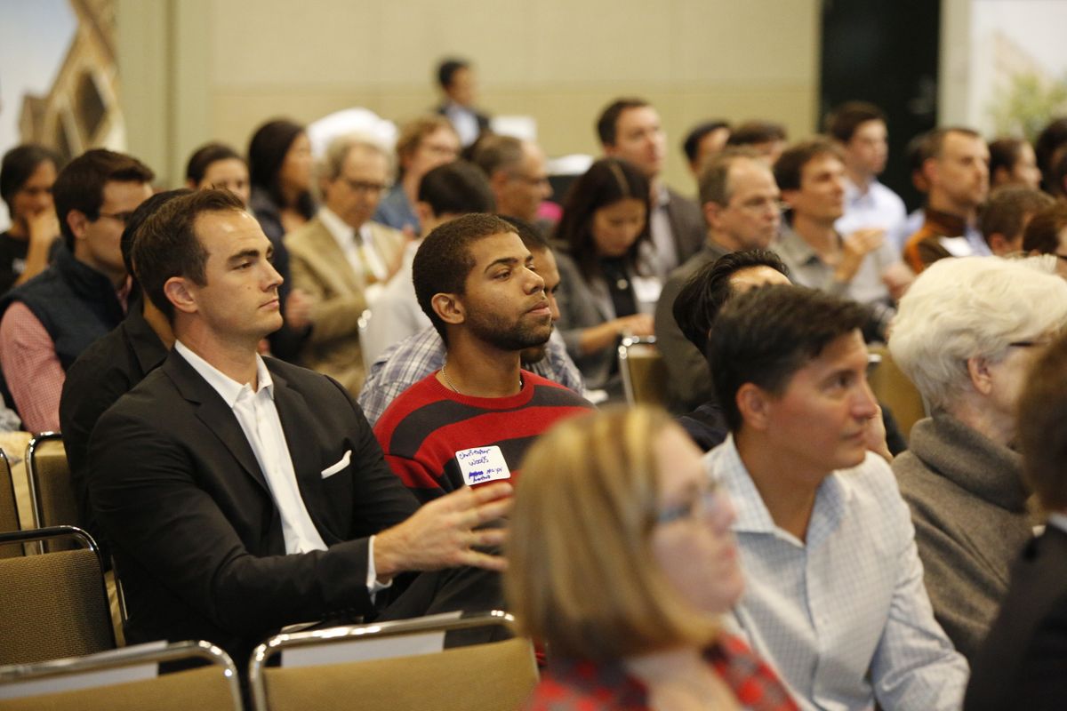 Audience listens to Ann Wang speak about her start-up, Enrou