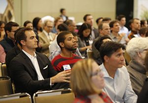 Audience listens to Ann Wang speak about her start-up, Enrou