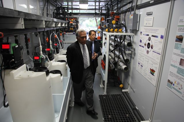 Yoram Cohen and Vijay Dhir inside mobile water treatment plant