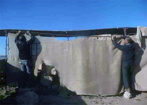 Workers at the Urkesh site protect some of the ruins.