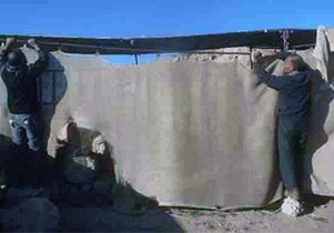 Workers at the Urkesh site protect some of the ruins.