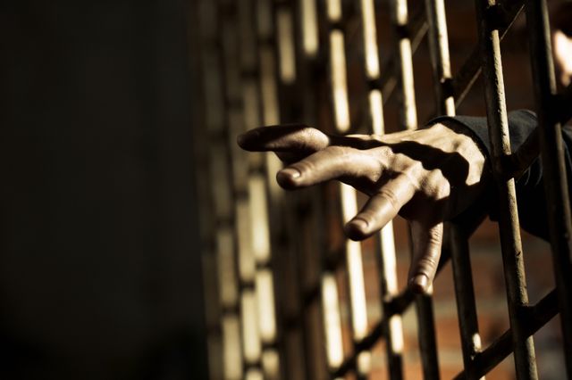 jail bars and an inmate