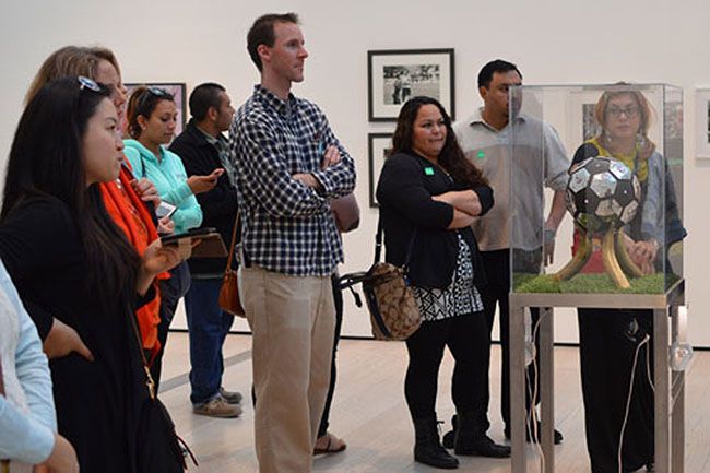 Teachers take a guided tour of a soccer exhibit at the Los Angeles County Museum of Art
