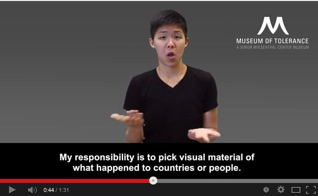 UCLA student Joanna Fan signs museum guide