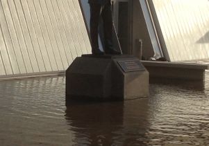 John Wooden statue flooded