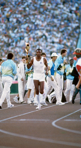 Gold medalist Rafer Johnson, a 1959 UCLA graduate, carried the Olympic torch into the Memorial Coliseum at the opening ceremonies