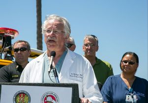 Dr. Gil Cryer at the podium during a press conference