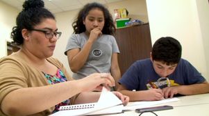 Arts educator Brianda Perez and middle-school students at St. Sophia's 