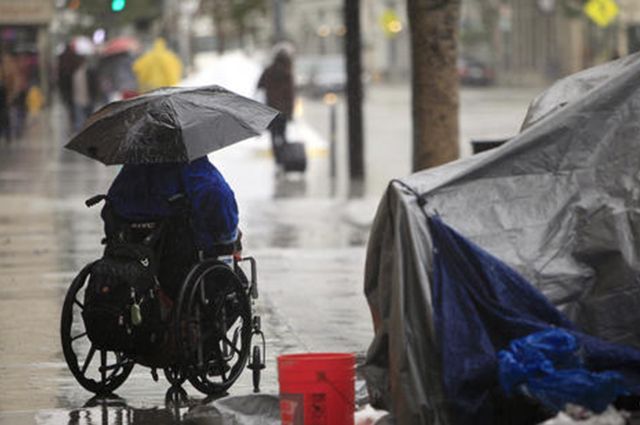 Homeless woman in the rain 