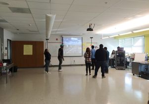High school students look at a 3-D cyber mural they created