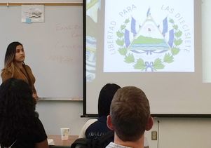 Student displays a graphic design she created to protest El Salvador's anti-abortion laws