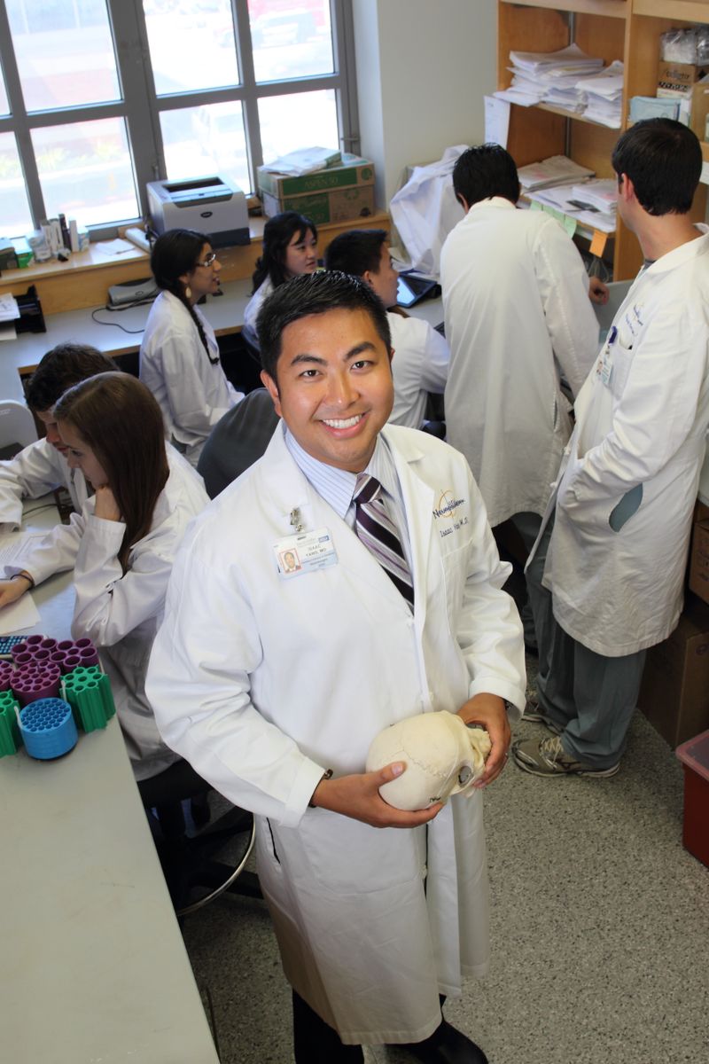 Dr. Isaac Yang with a model of the human brain