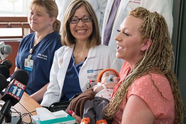 Janine Carr, pediatric cardiac nurse; Adrianne Belay, pediatric heart transplant coordinator and Dravyn Johnson with his mother, Nicole Eggleston.