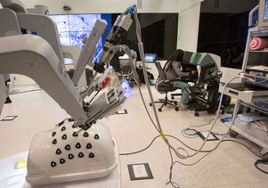 Resident learns to operate surgical robot
