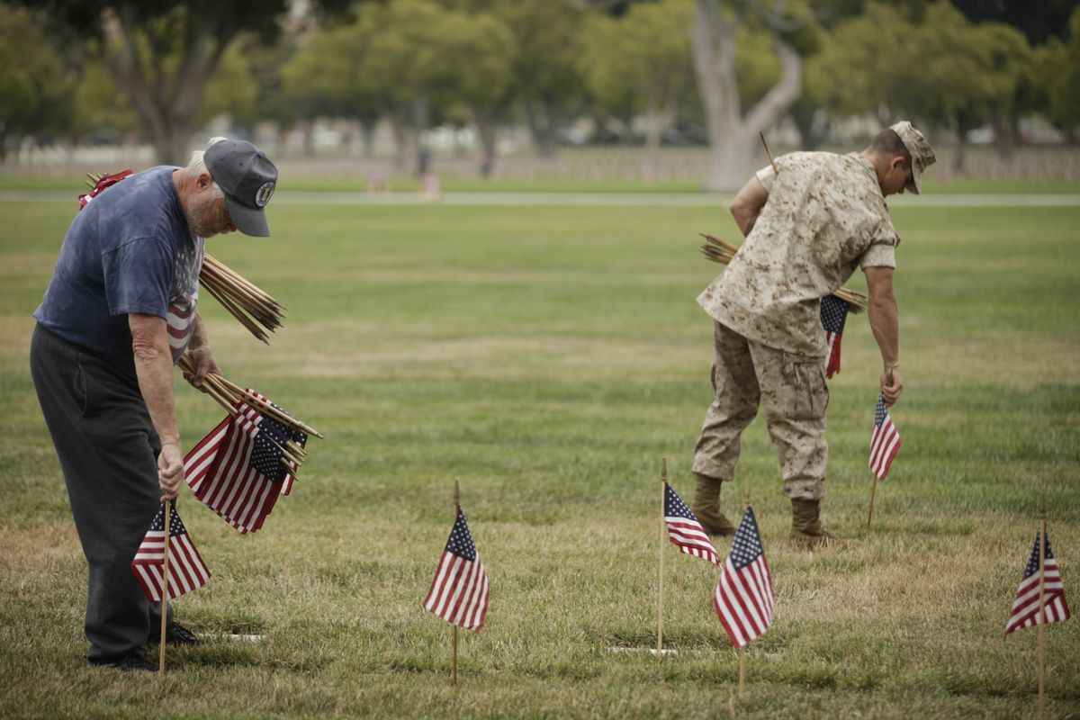 Volunteers pick up flags after Memorial Day