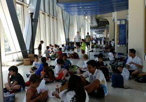 Kids attending camp take a break in Pauley Pavilion