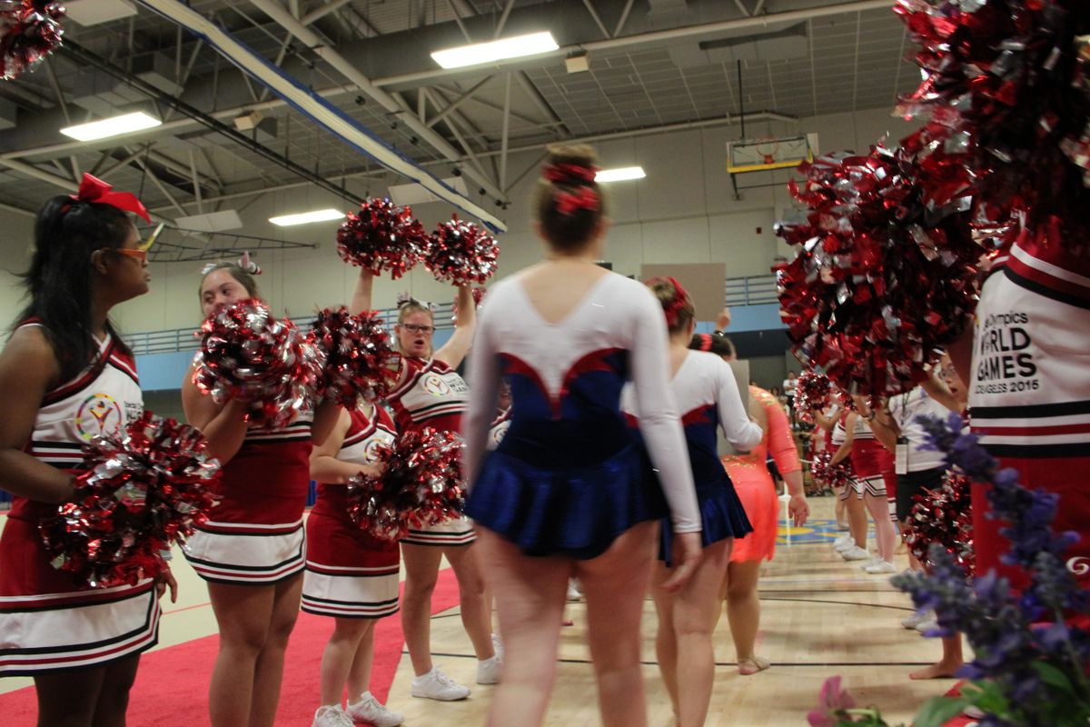 Cheerleaders and athletes competing in rhythmic gymnastics