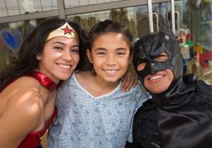 Patient Sky Assaf with Wonder Woman and Batman