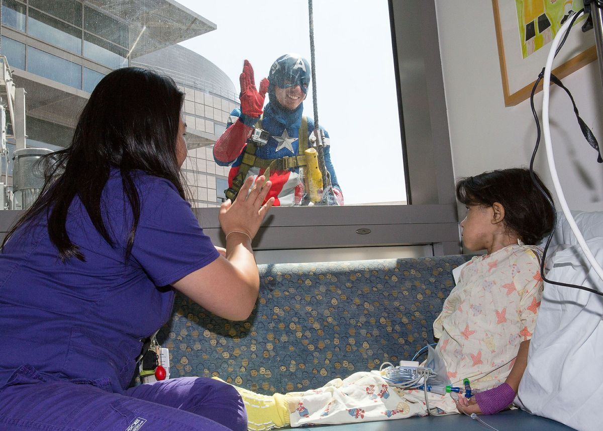 Captain America greets a patient