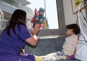 Captain America greets a patient
