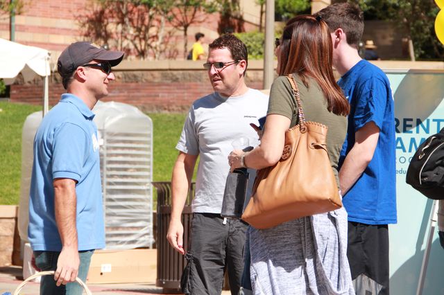 Parent volunteer Bob Murphy greets the Wolpert family