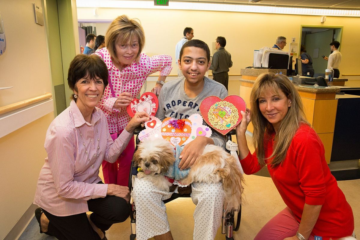 Patient Ali surrounded by members of Dollies Making a Difference and UCLA's People-Animal Connection 