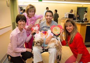 Patient Ali surrounded by members of Dollies Making a Difference and UCLA's People-Animal Connection 