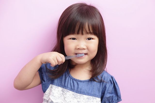 Girl with toothbrush