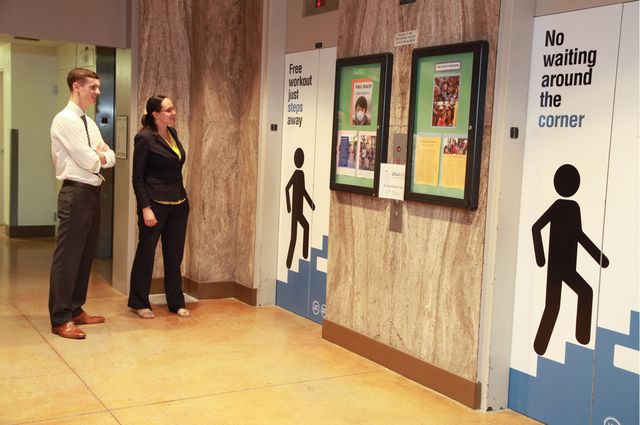 People see signs encouraging them to take the stairs for exercise